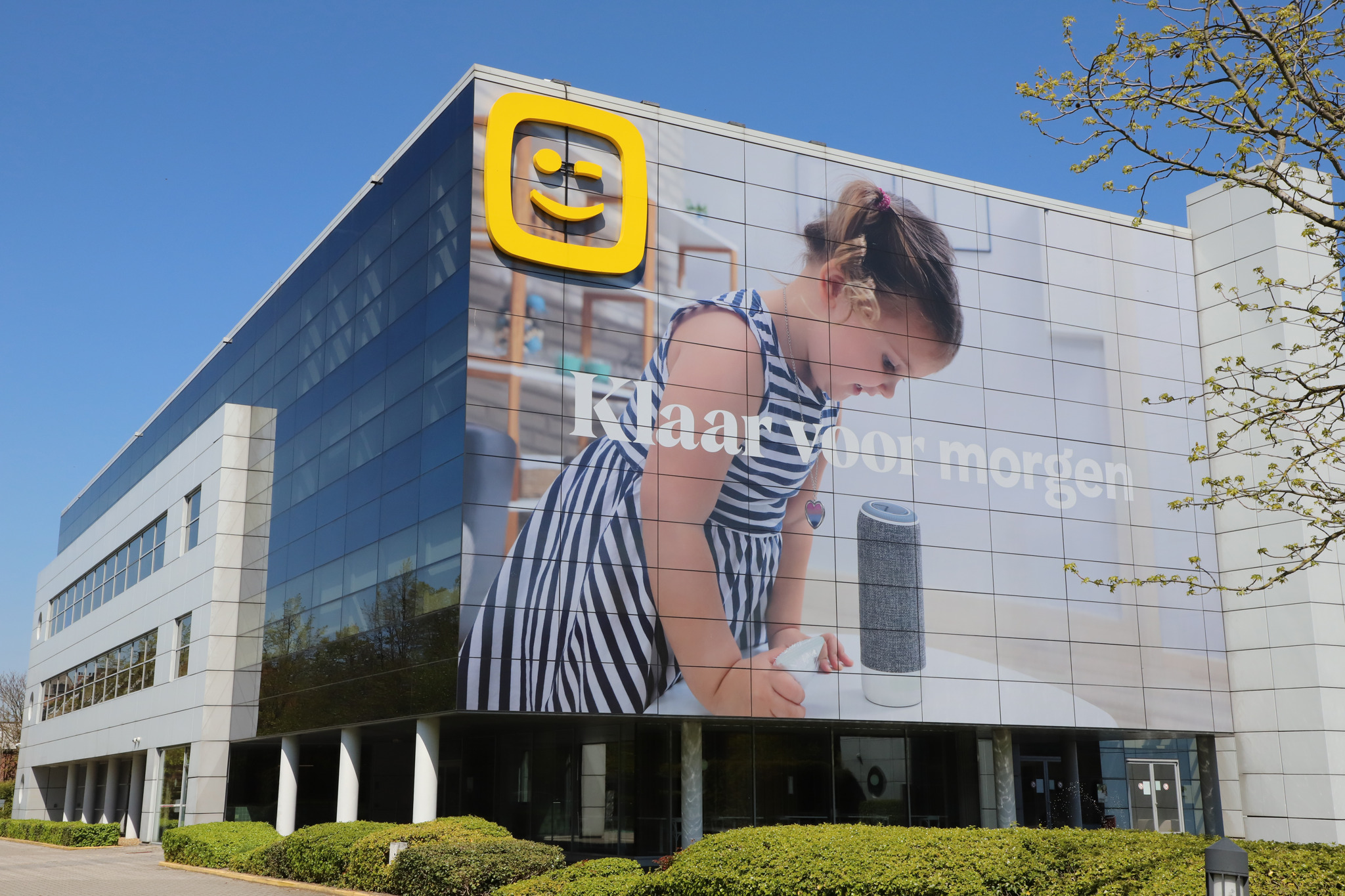 The Telenet office building, its logo on the roofline above a full-height photographic banner