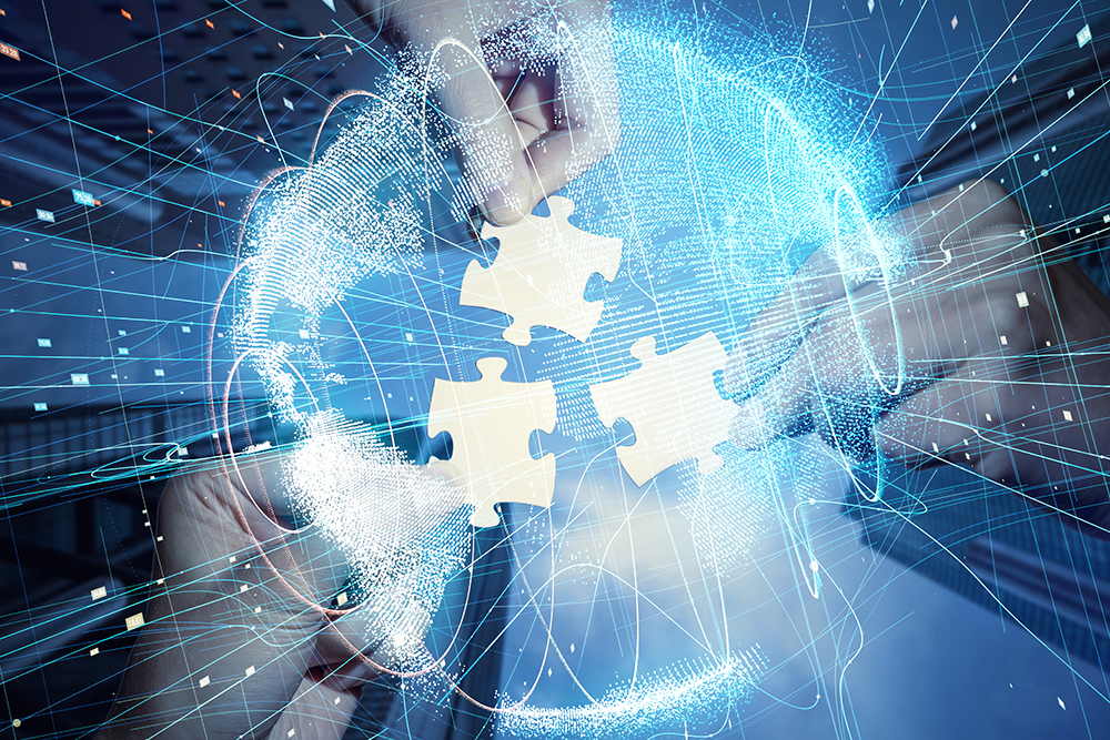 Hands fitting jigsaw pieces together over a globe traced with network connections