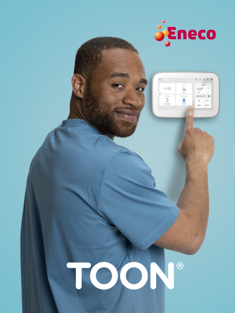 A man interacting with a Toon smart thermostat mounted on a wall, representing Eneco’s innovative energy solutions.