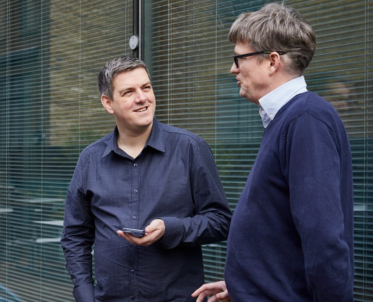 Two colleagues talking outside the office